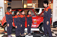 Service bay mockup where children can try their hands at changing a tire and other simulated car maintenance tasks