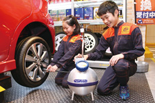 Service bay mockup where children can try their hands at changing a tire and other simulated car maintenance tasks